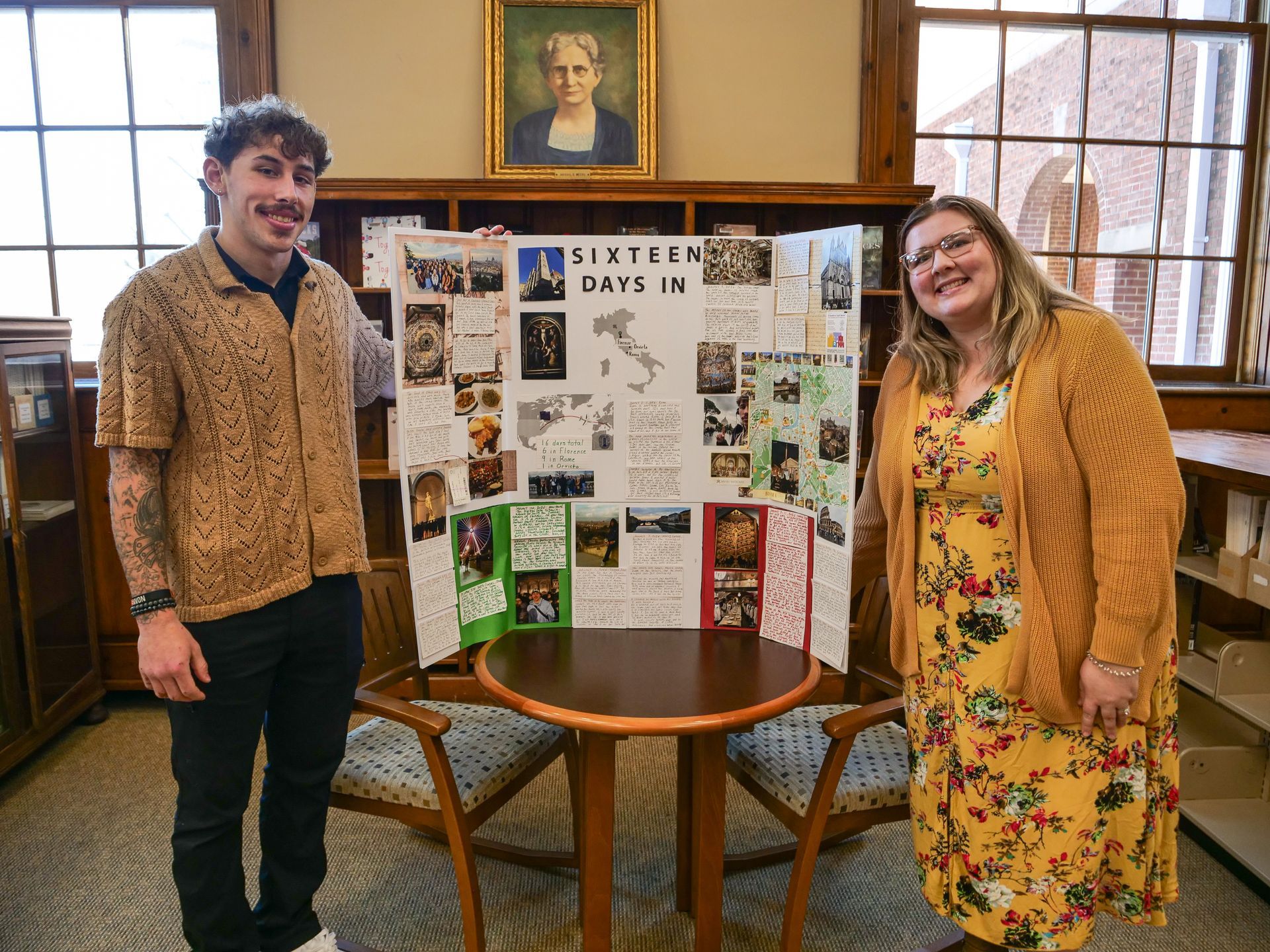 Tate Spayd standing with Rachel Williams and his poster on his experience with the study abroad program in Florence and Rome.