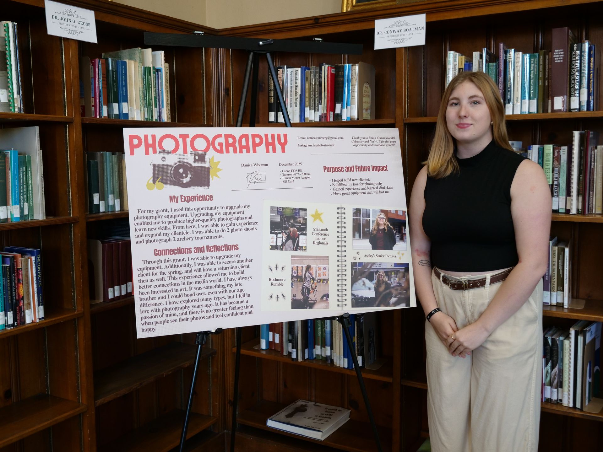 Danica Wiseman standing with her poster on upgrading her photography equipment and reflecting on her technical skills.