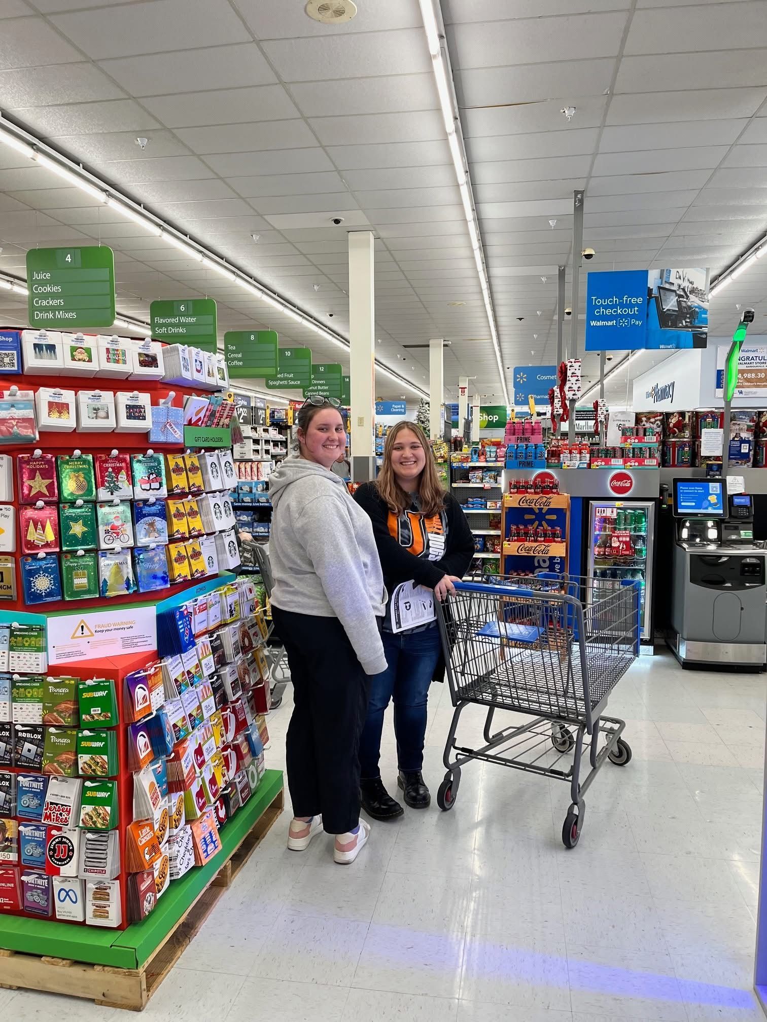 Union students shopping and smiling in Walmart.