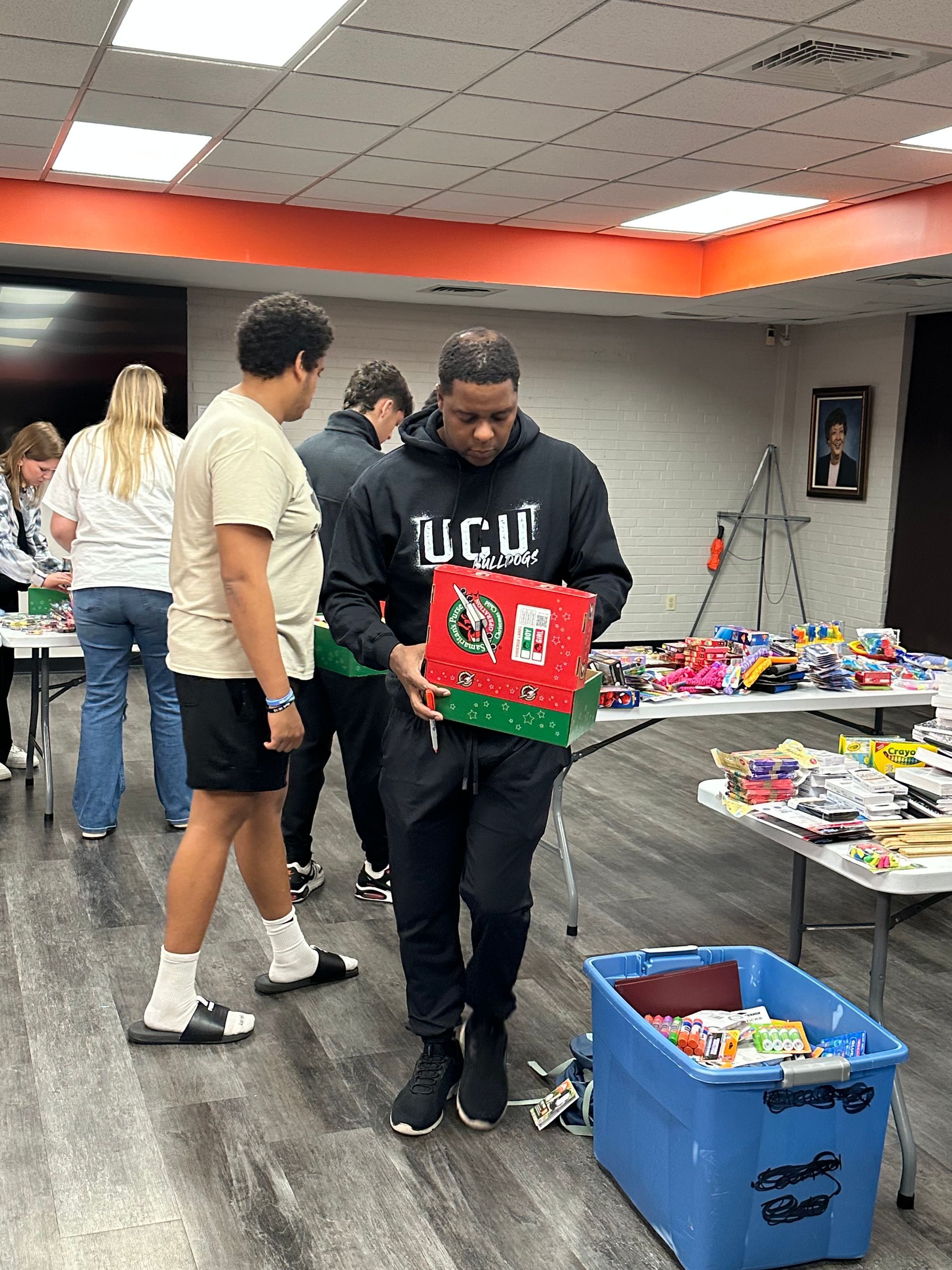 Dr. Washington and Union Students pack gifts into shoeboxes.