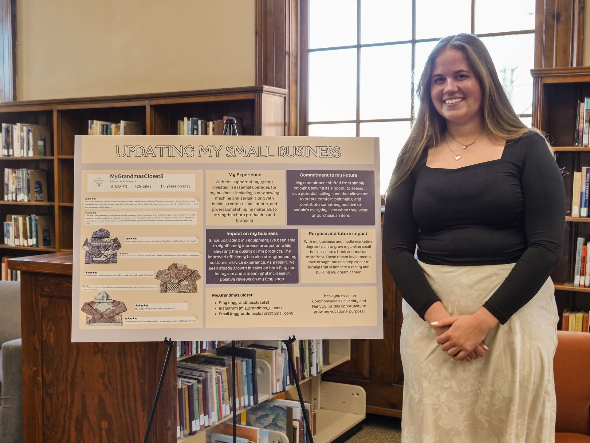 Ava Noehre standing with her poster on expanding her handmade sewing business.