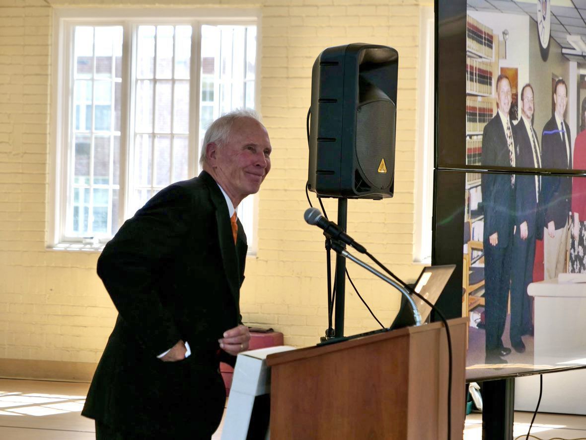 Inkster smiling at podium during retirement party.