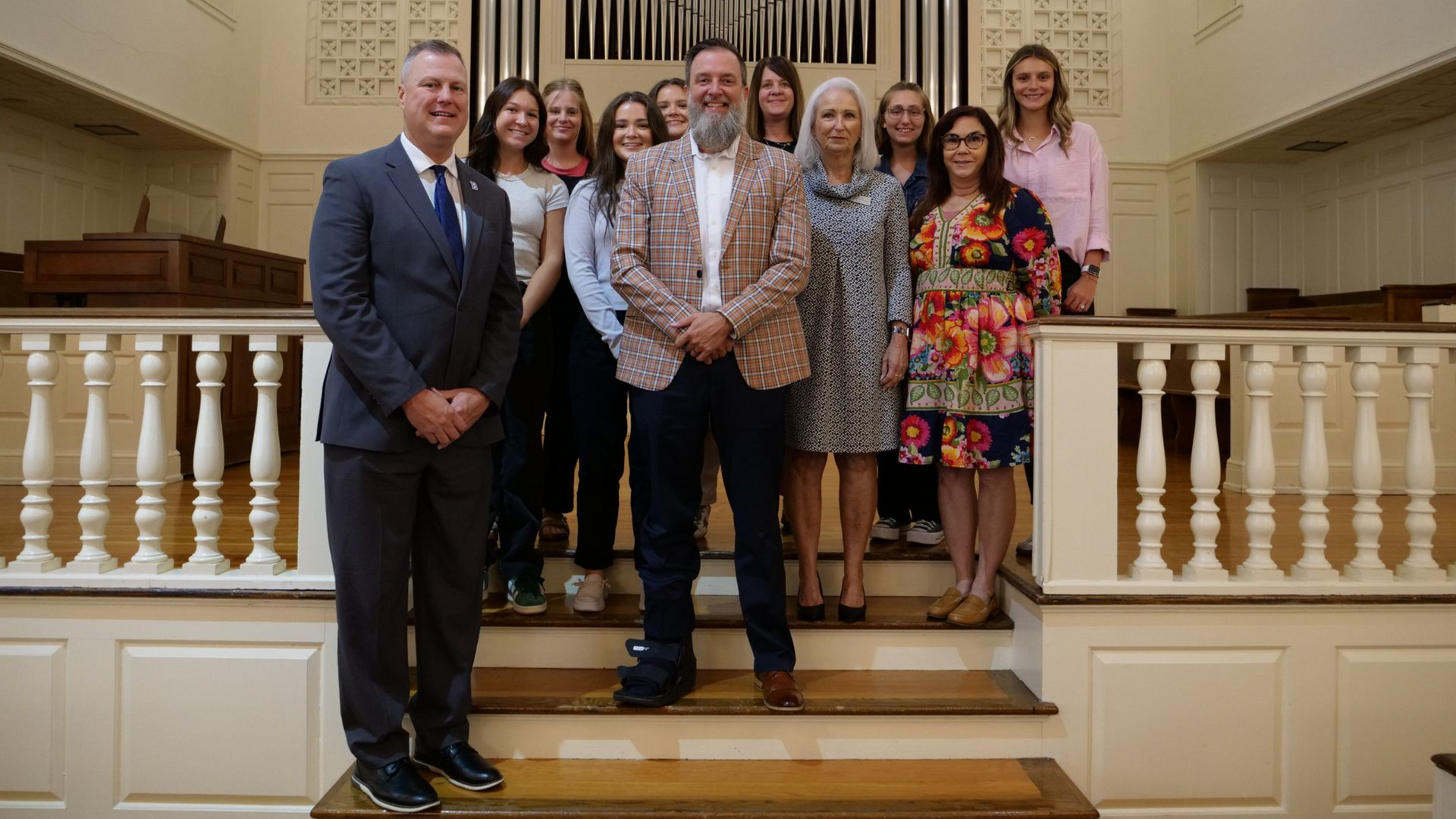 Superintendent Dennis Messer, Superintendent Jeremy Ledford, Wanda Carol Clouse, and Dr. Lori Henderson standing on the Conway Boatman Chapel stage with Union Commonwealth University students.