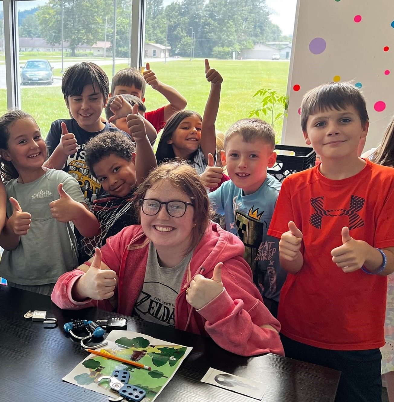 Kids giving a thumbs up gesture during a Boys & Girls Club activity.