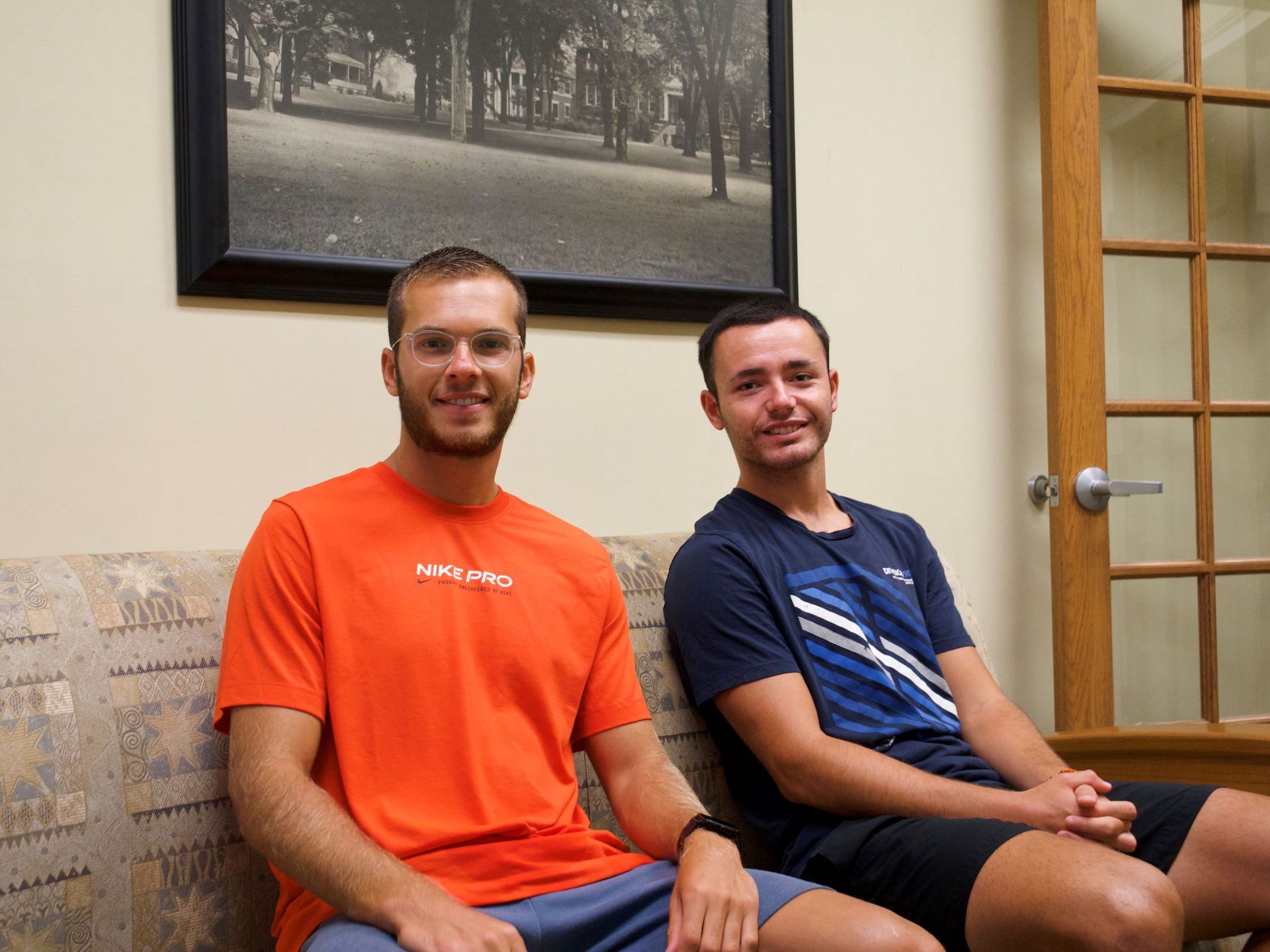 Yaniv Zion and Carlos Sainz Barroso sit on a couch in the new International Student Services office.