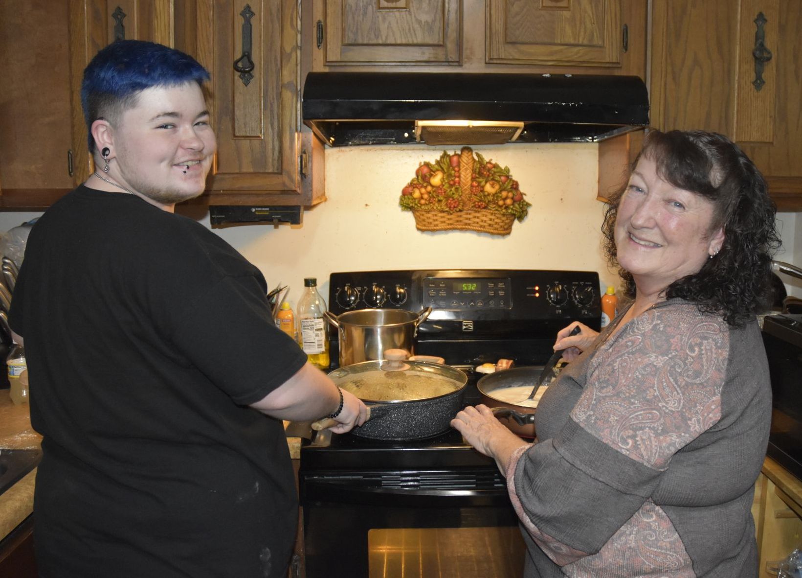 Conner and Barbara Saylor cooking food in the Saylor family kitchen.