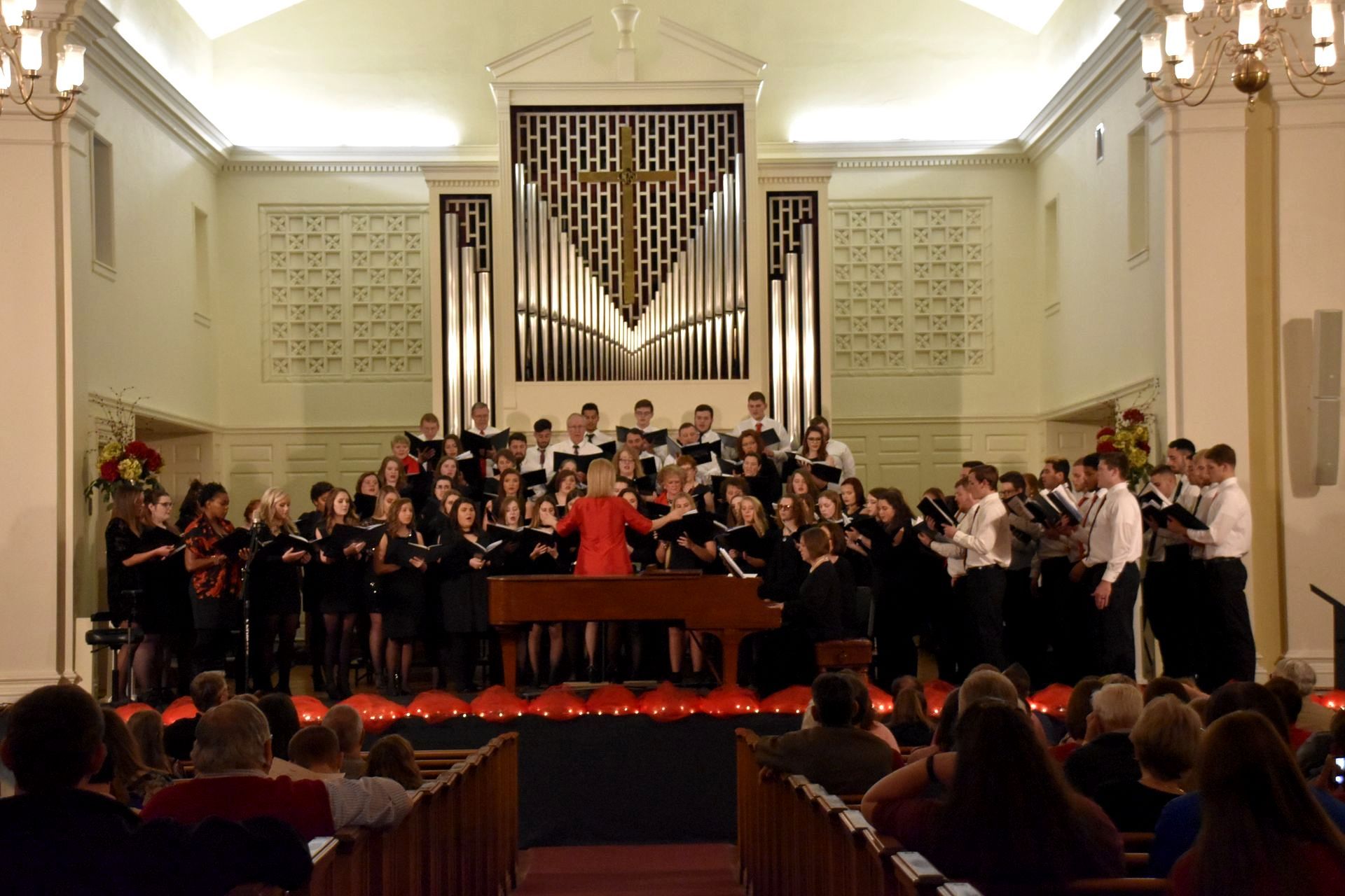 Union Singers, Union Harmony, and the Regional Chorus performing on stage at a concert under the guidance of Dr. Virginia Gay Gandy.