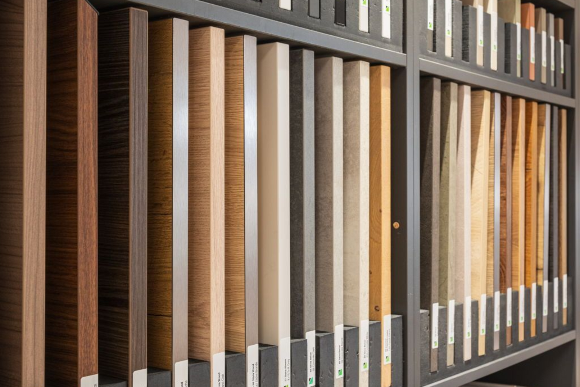 Display of various wood samples in a store, showing different colors and grain patterns.