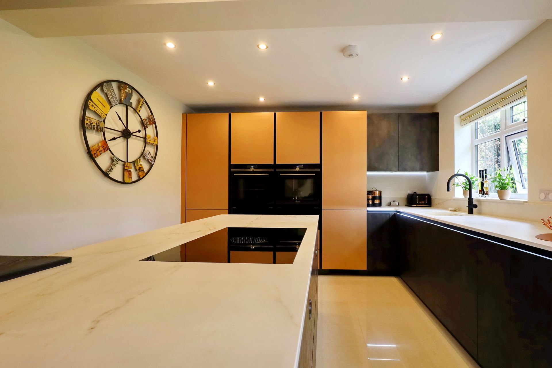 Harvey contemporary kitchen with grey, handleless units and teal furnishings. Designed by exact Kitchens in Wokingham.