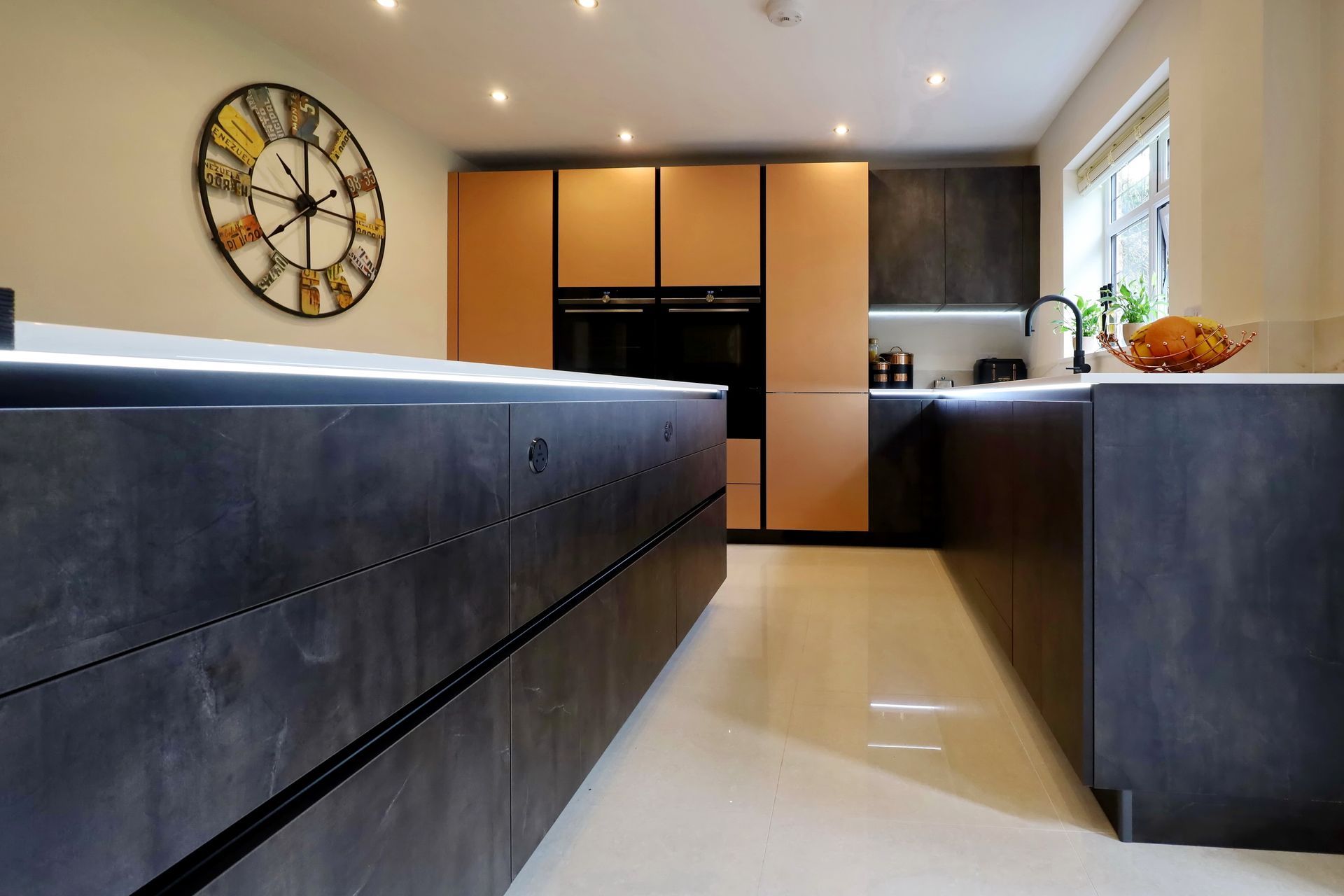 Harvey contemporary kitchen with grey, handleless units and teal furnishings. Designed by exact Kitchens in Wokingham.