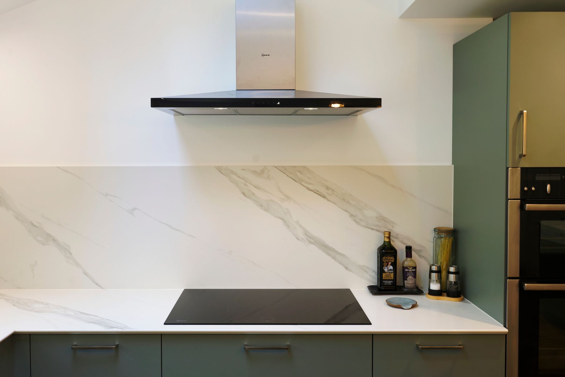 Modern bathroom with gray tiles, a lighted round mirror, and a floating vanity.