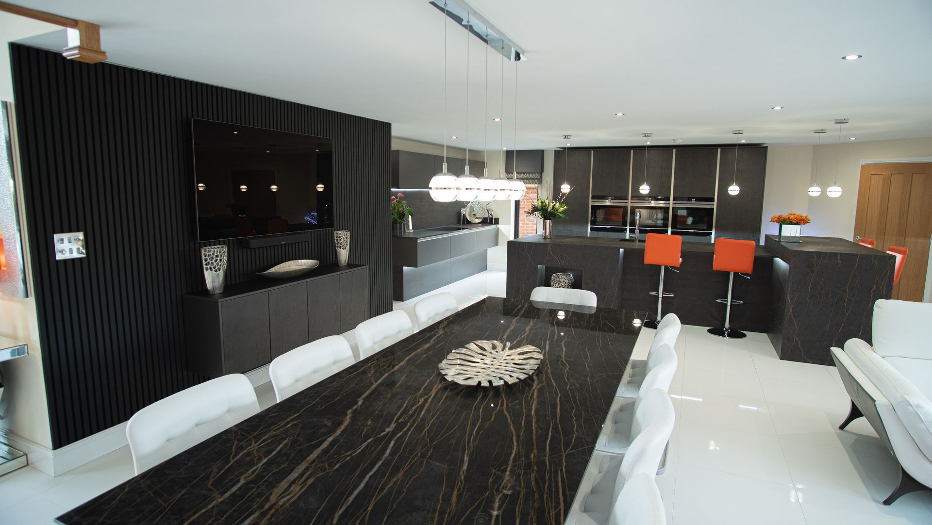 Harvey contemporary kitchen with grey, handleless units and teal furnishings. Designed by exact Kitchens in Wokingham.
