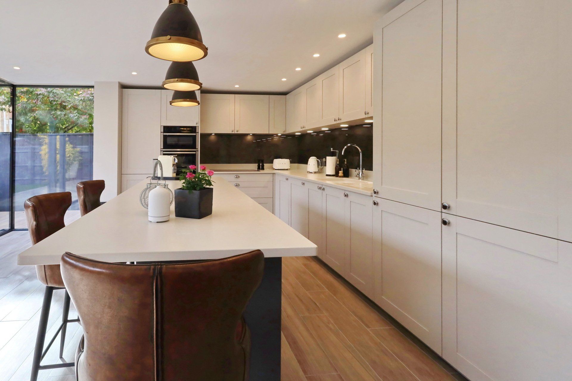 Harvey contemporary kitchen with grey, handleless units and teal furnishings. Designed by exact Kitchens in Wokingham.