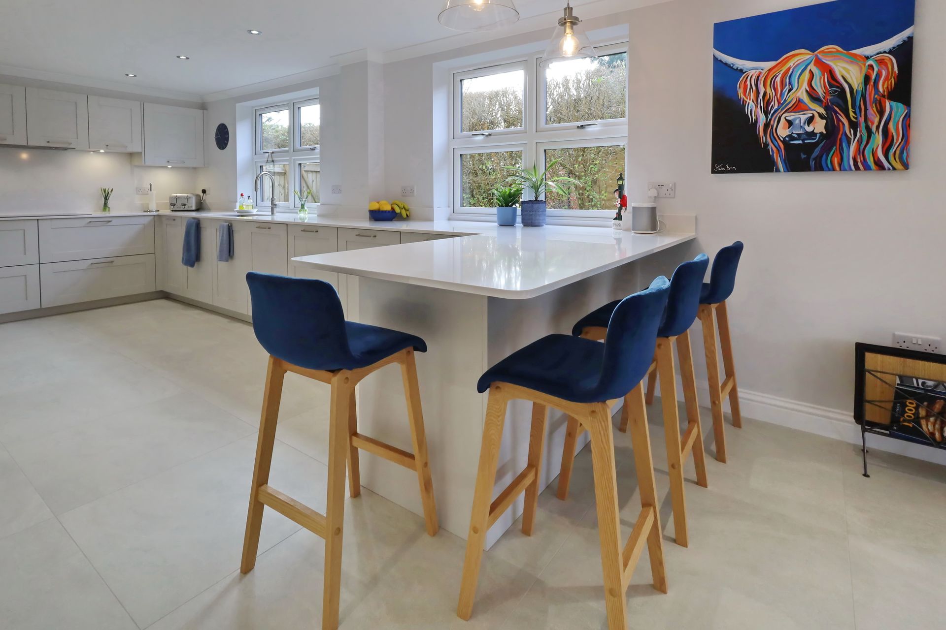 Harvey contemporary kitchen with grey, handleless units and teal furnishings. Designed by exact Kitchens in Wokingham.