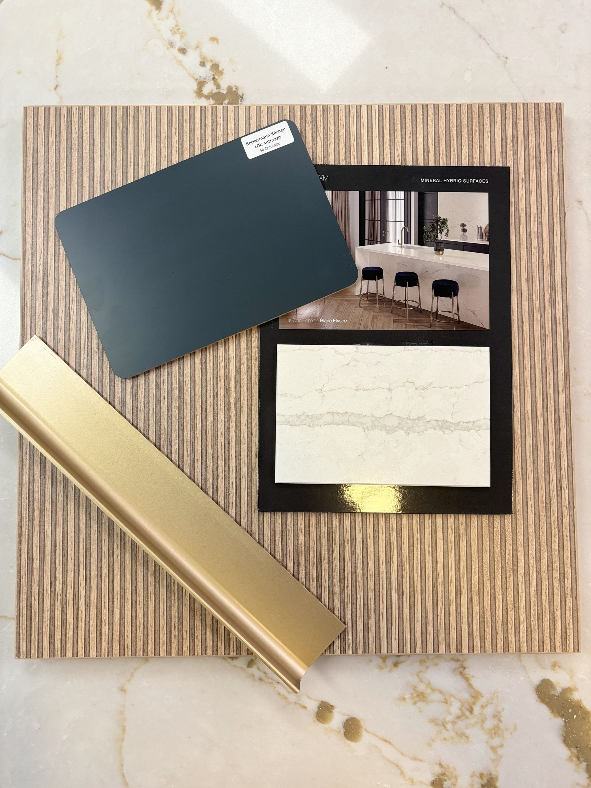 Mood board with teal paint swatch, gold trim, and interior design inspiration against a textured background.