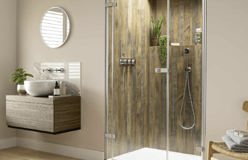 Bathroom with wood-paneled shower, glass door, floating vanity, round mirror, and plants.