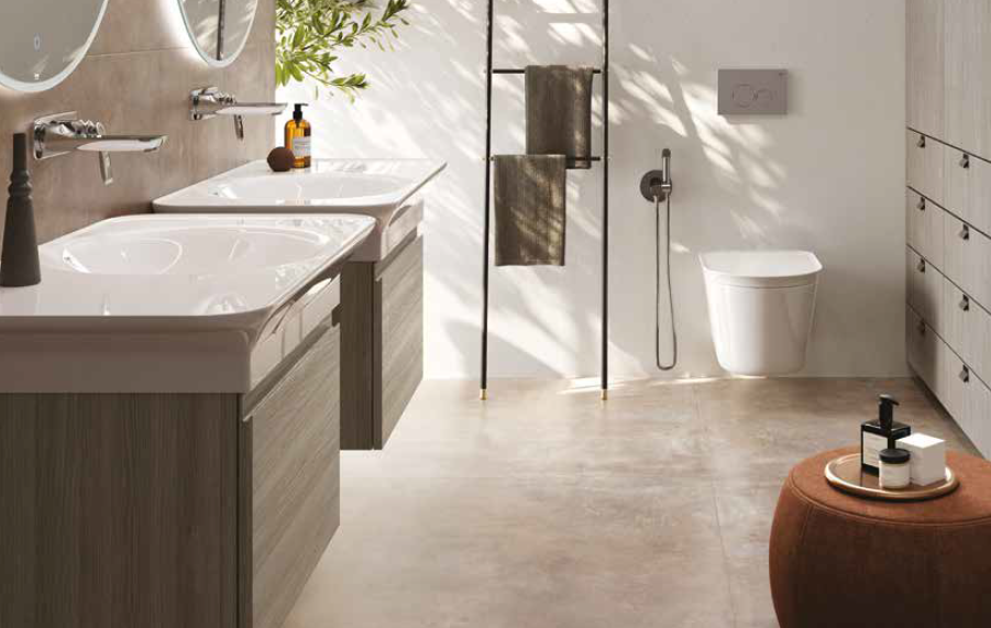 Modern bathroom with dual sinks, toilet, towel rack, and brown stool.
