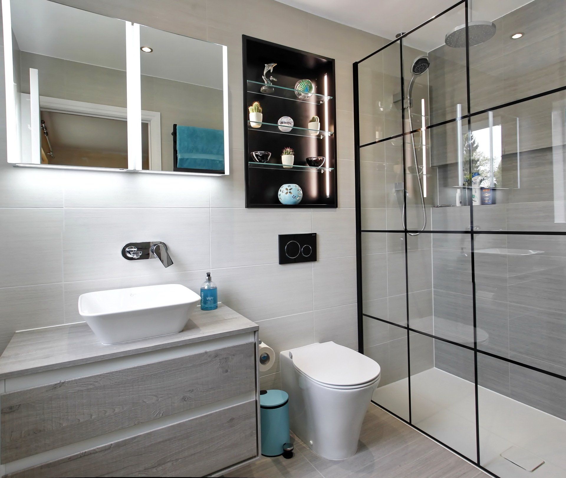 Modern bathroom with a glass shower, floating vanity, and mirrored medicine cabinet.