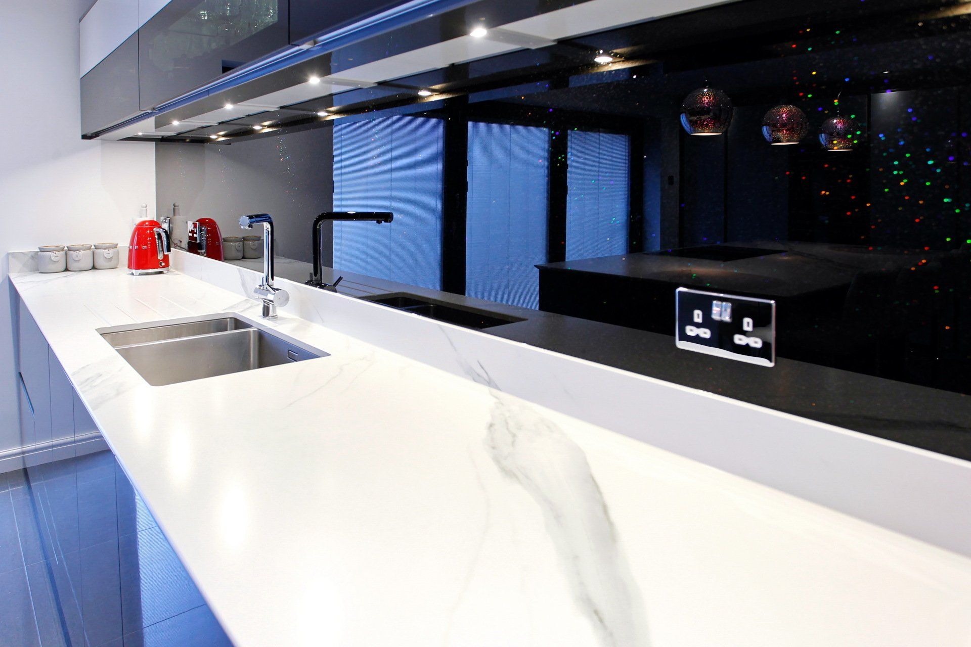 Harvey contemporary kitchen with grey, handleless units and teal furnishings. Designed by exact Kitchens in Wokingham.