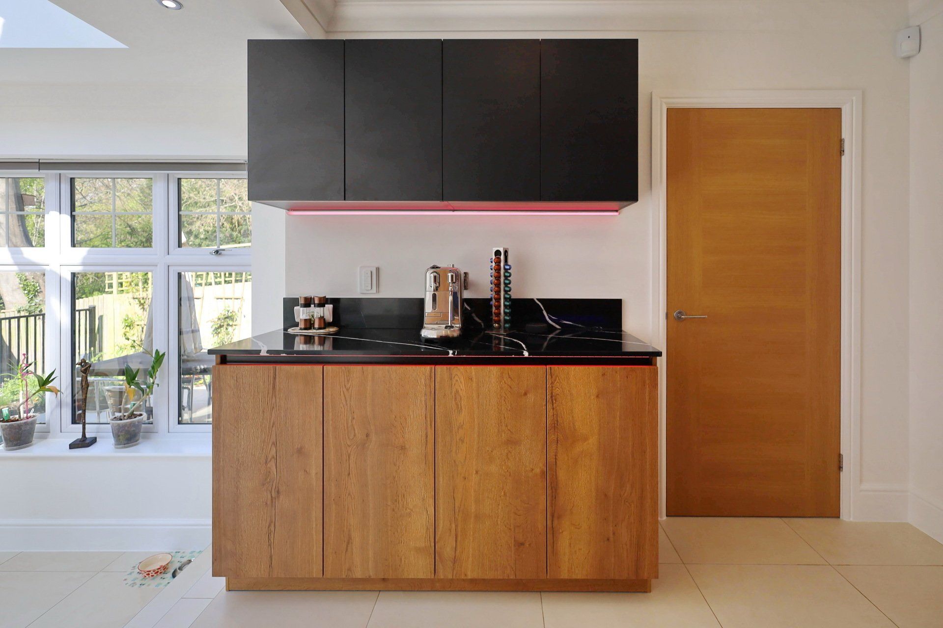 Harvey contemporary kitchen with grey, handleless units and teal furnishings. Designed by exact Kitchens in Wokingham.