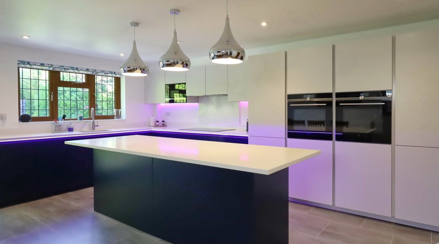 Harvey contemporary kitchen with grey, handleless units and teal furnishings. Designed by exact Kitchens in Wokingham.