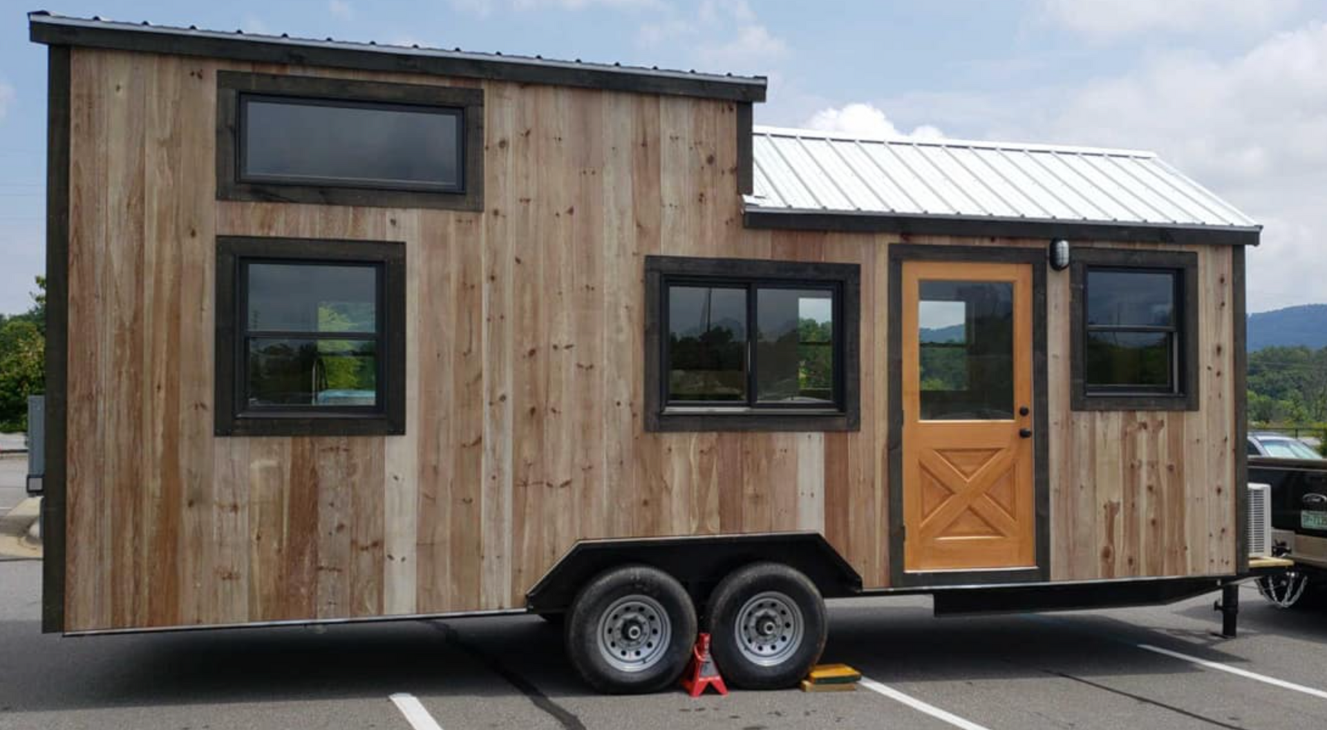 Tiny house on wheels with natural wood siding installed by Nanostead in Barnardsville, NC.