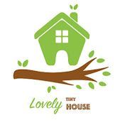 A green house is sitting on top of a tree branch.