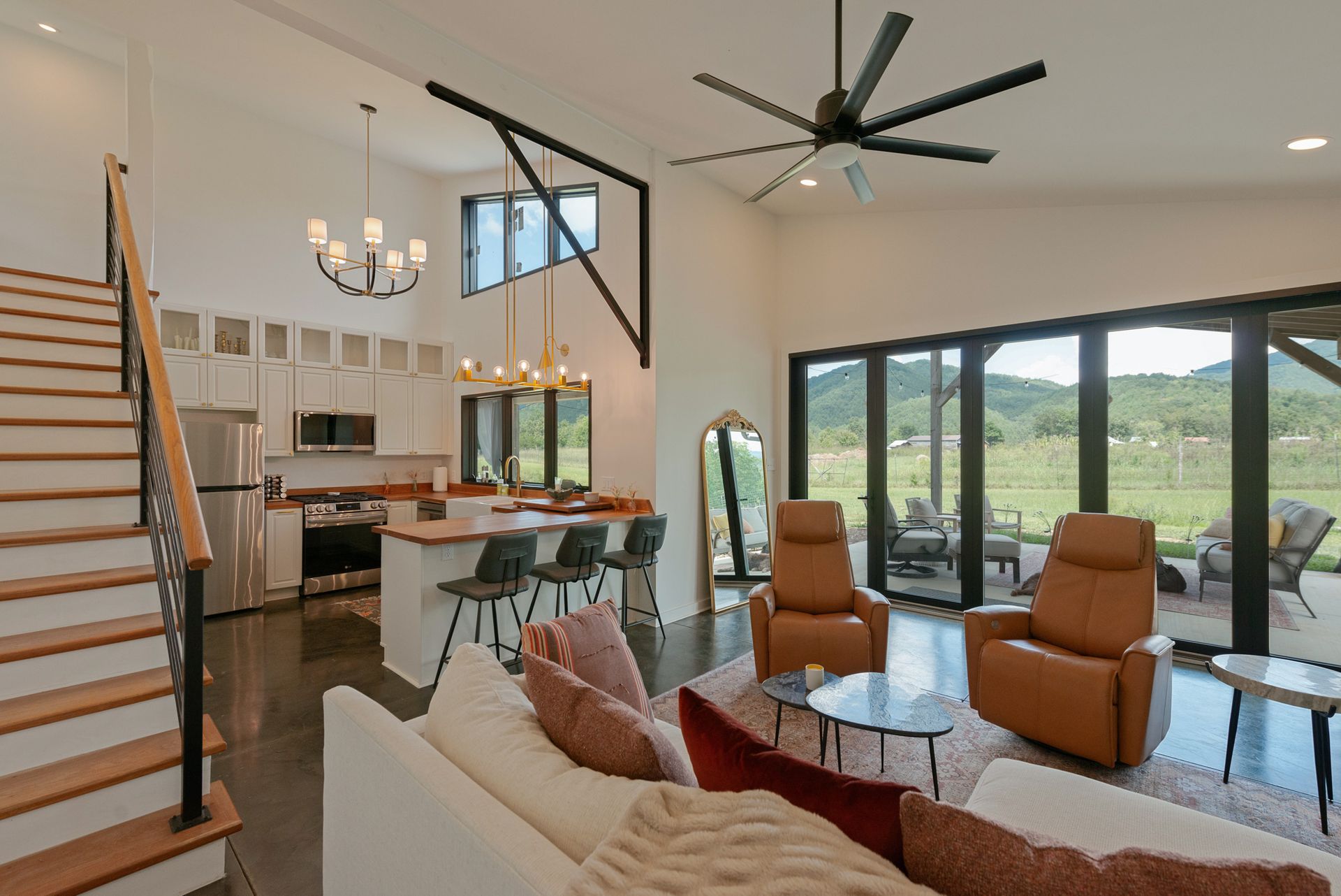 living room, stairs, and kitchen in tiny home