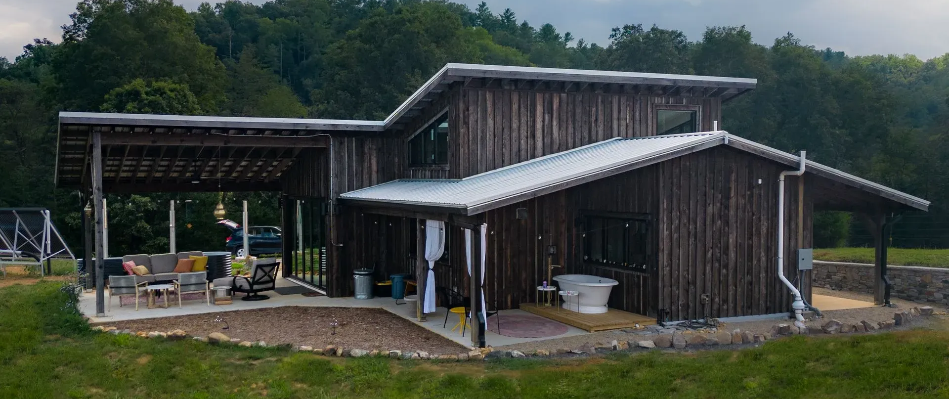Nanostead's 882 sq ft Paint Rock Road net zero ready home in Hot Springs, NC, with folding glass wall and greenhouse