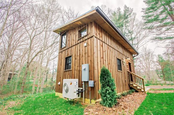 A small wooden house in the middle of a forest.