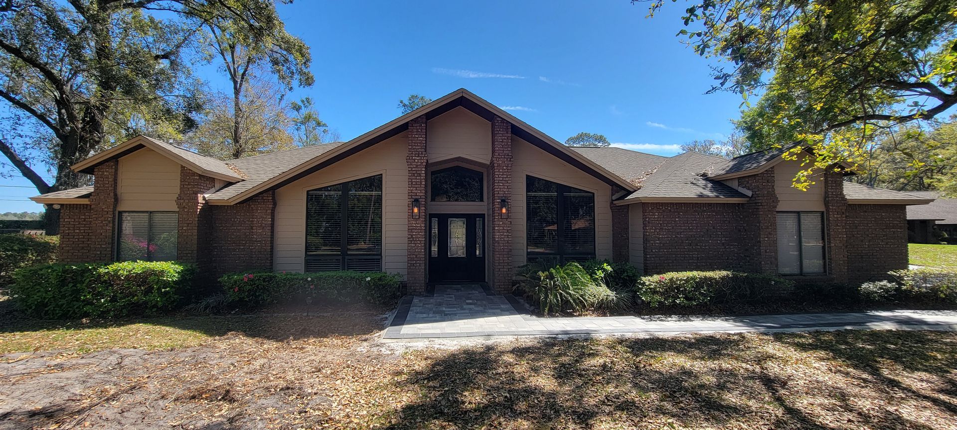 A large brick house with a lot of windows is for sale.