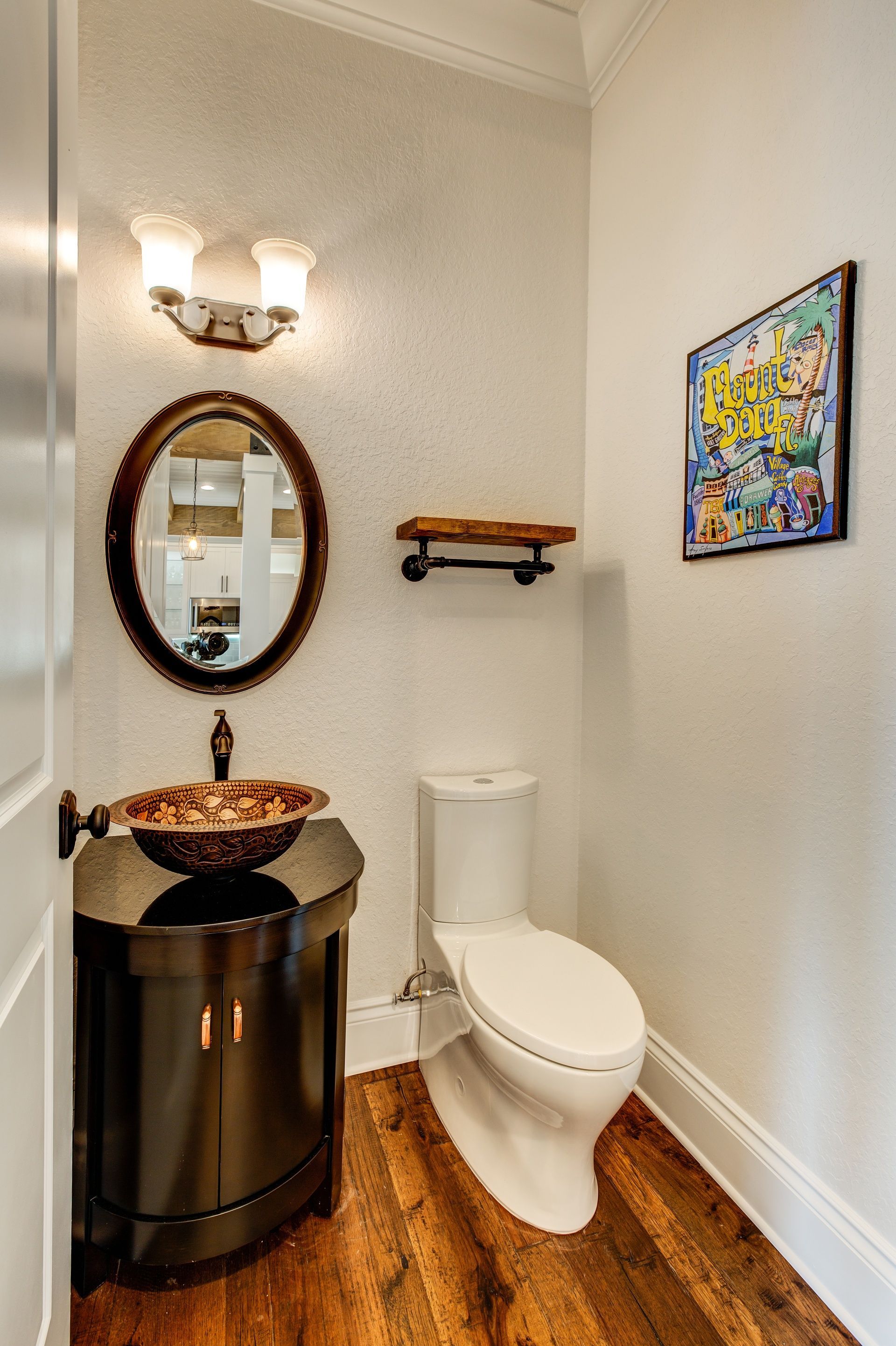 A bathroom with a toilet a sink and a mirror