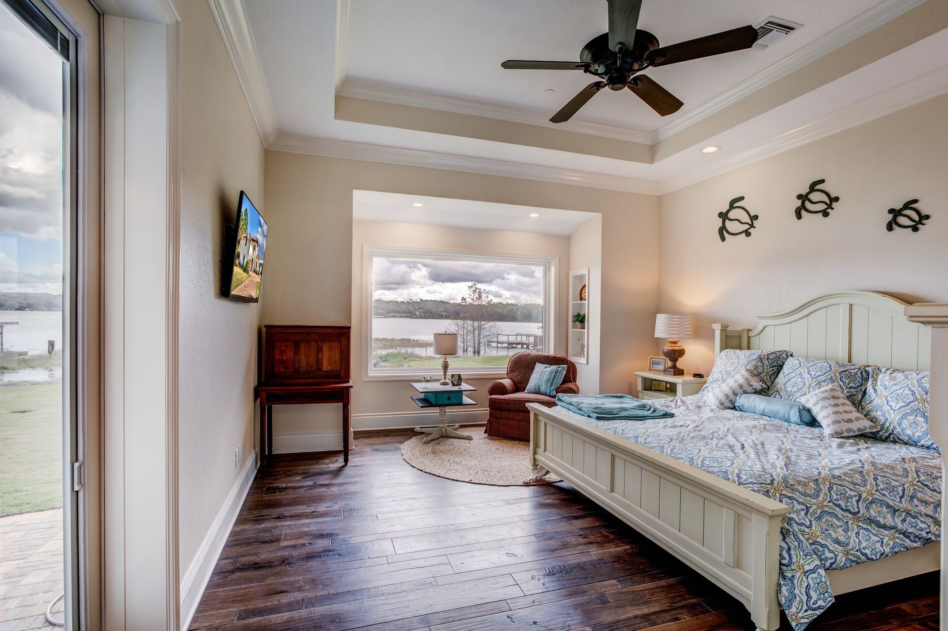 A bedroom with a large bed and a ceiling fan.