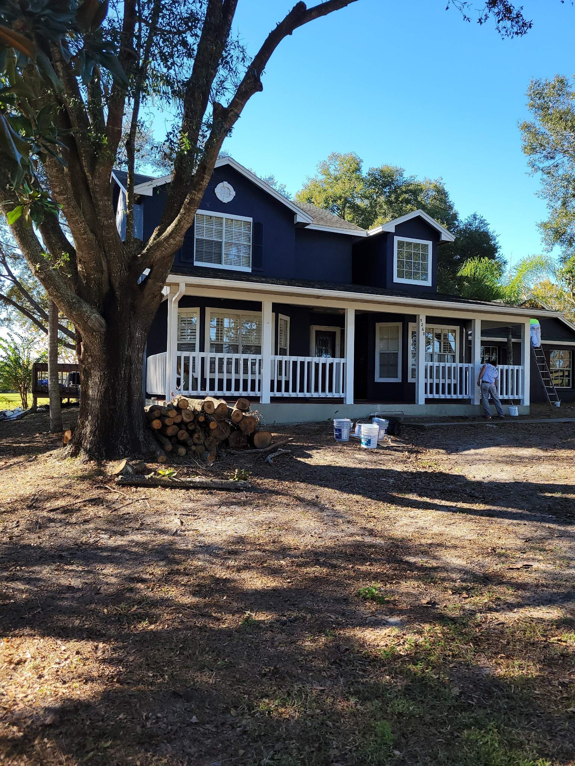 A black and white house with a large porch