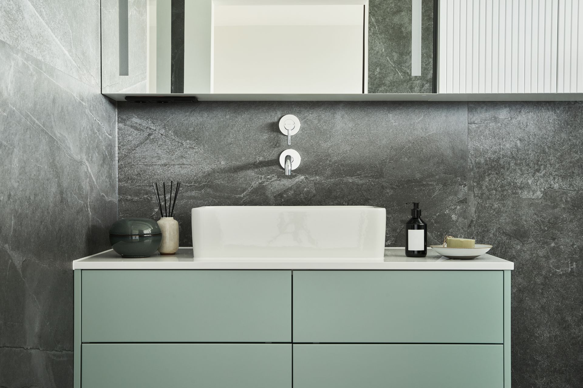 A bathroom with a sink and a mirror.