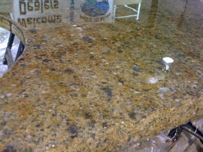 Brown speckled granite countertop with a small white knob or cap on the right side.
