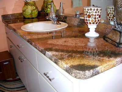 Bathroom vanity with granite countertop, white sink, and decorative items.