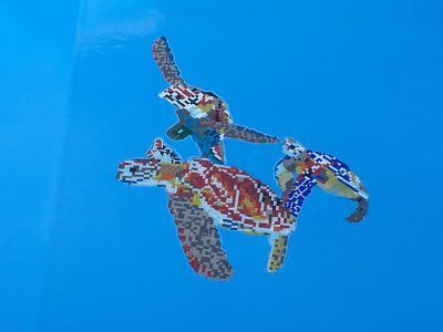Colorful mosaic of a horse-and-rider figure on a bright blue background