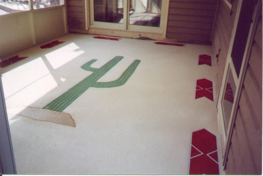 Indoor hallway with a large green cactus-shaped floor design and red diamond accents on a white carpet