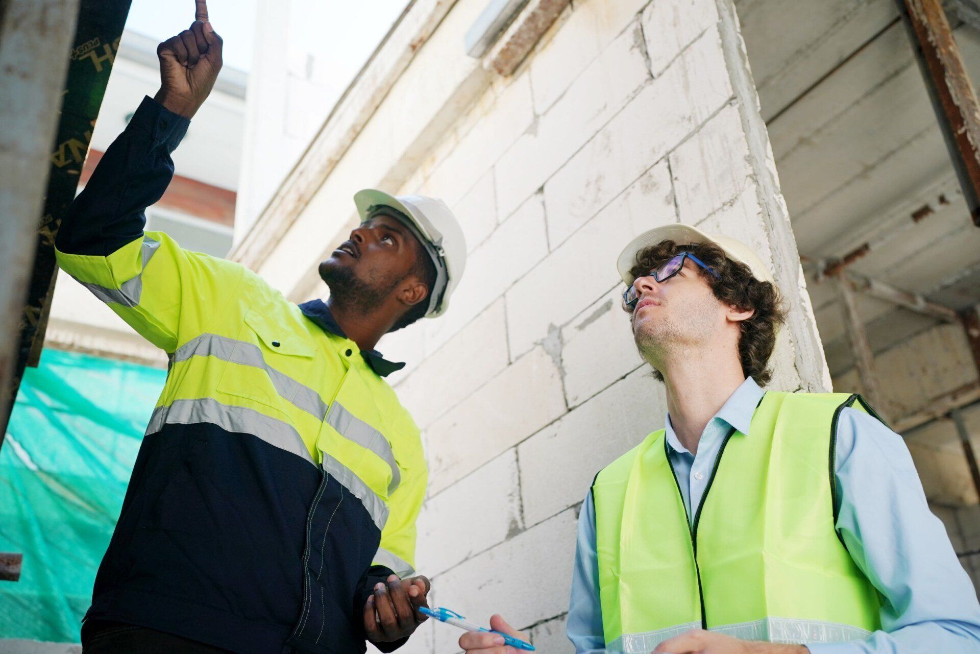 Architect and construction engineer or surveyor discussion plans and blueprints