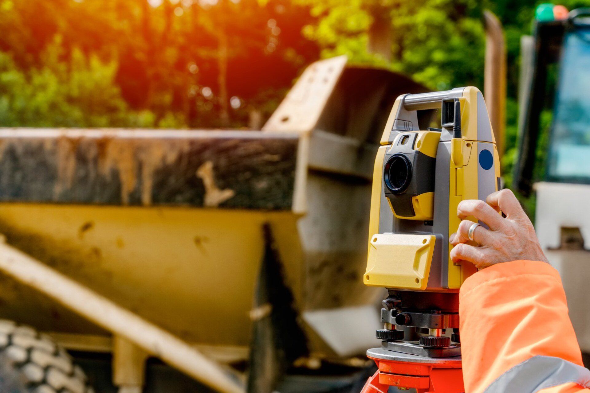Surveyor site engineer with total positioning station on construction site of new road construction