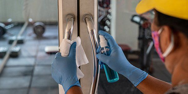 Cleaning The Handle Of The Glass Door — Carpet Cleaning In Townsville QLD