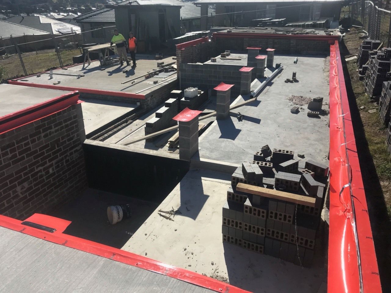 A construction site with a lot of bricks on the ground — Advanced Pest Control Wollongong in Albion Park Rail, NSW