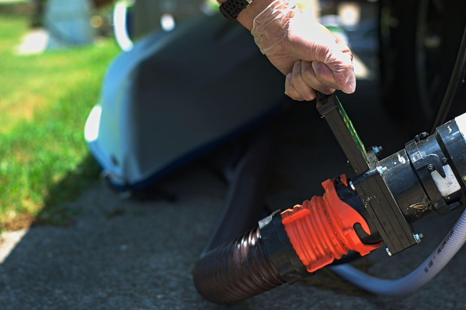 A person is holding a hose with a handle on it.