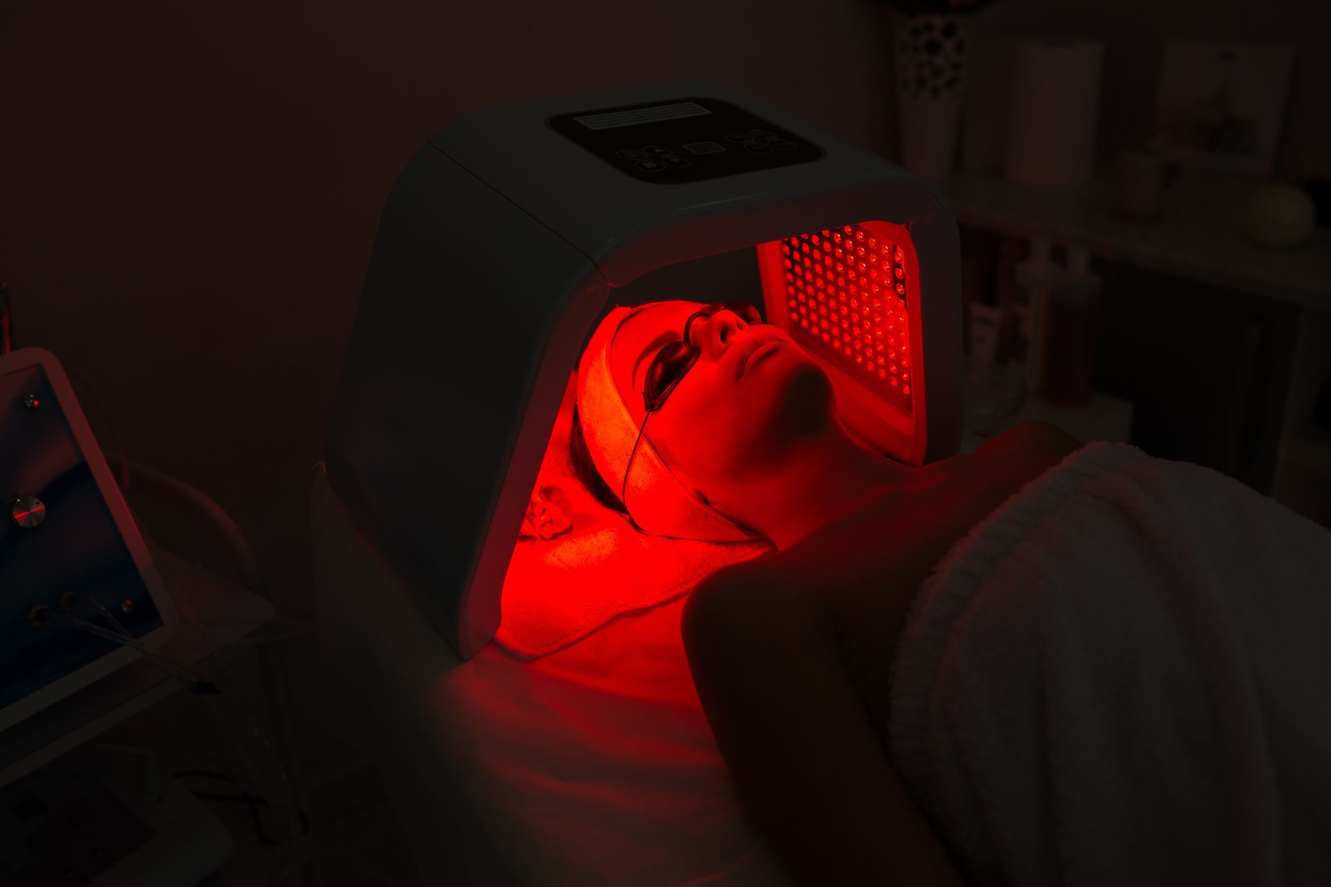 Woman having red light face therapy