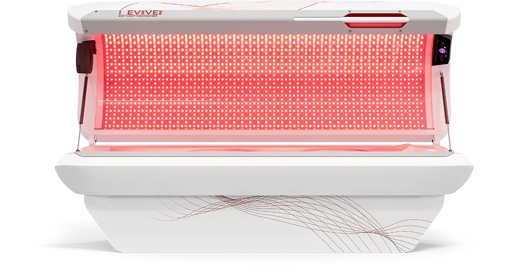 Red light therapy bed, white exterior, emitting red light.