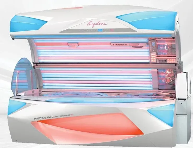 Tanning bed with blue and red lights; white exterior with 
