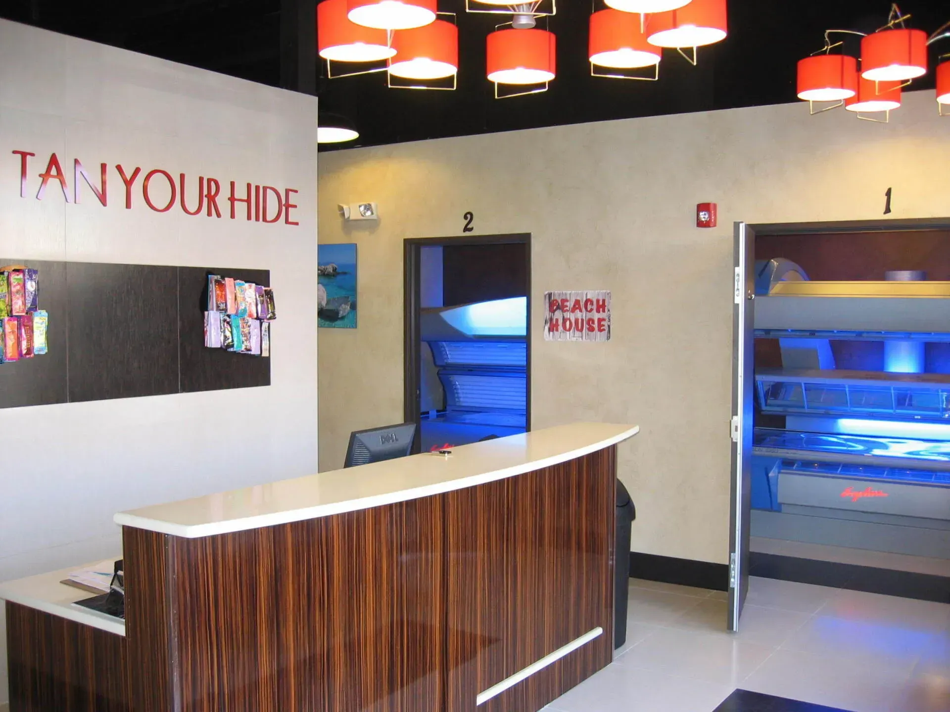 Interior of a tanning salon with reception desk and tanning beds.