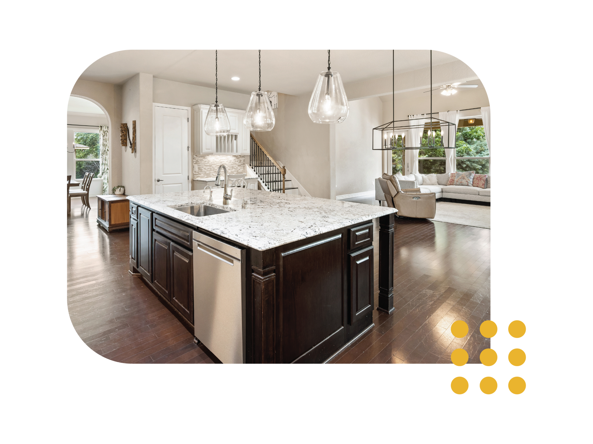Modern kitchen with dark wood island, marble countertops, pendant lights, and open living area.