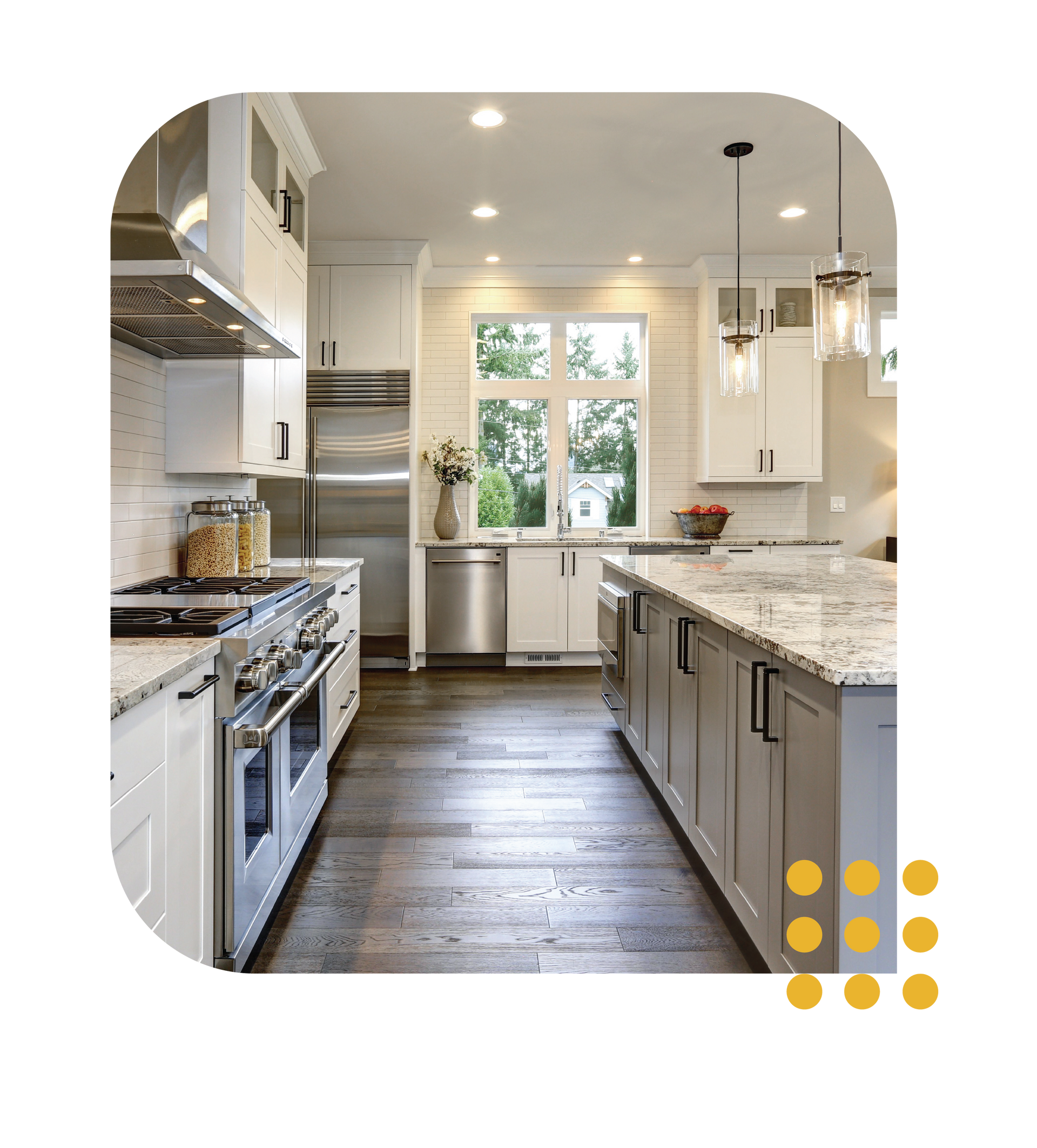 Bright modern kitchen with stainless appliances, white cabinets, and granite island, viewed from the center aisle